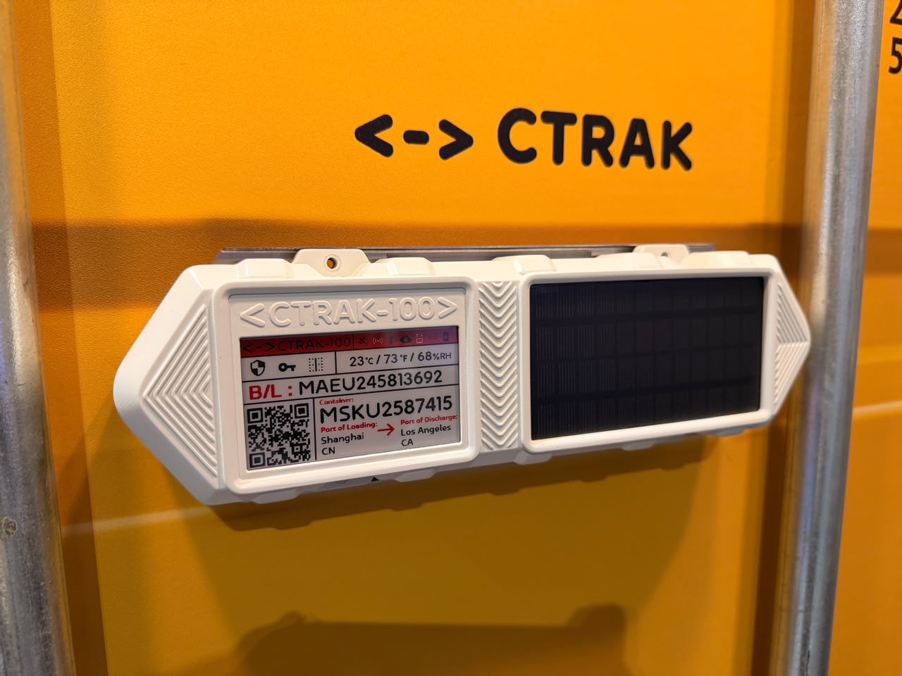 CTRAK-100 installed on a shipping container, showing its eInk display and solar panel